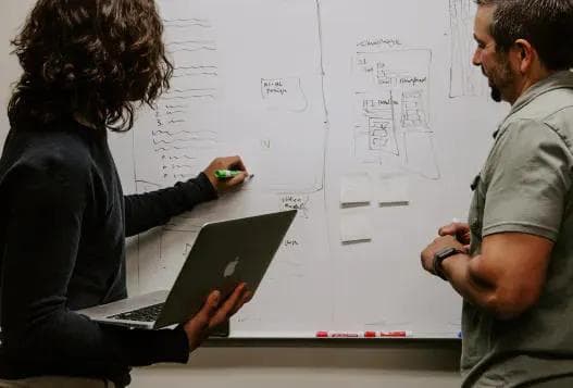 A woman writing on a whiteboard
