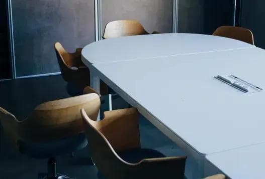 A conference table surrounded by chairs